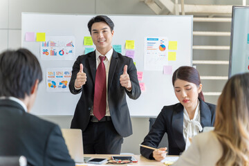 A group of young Asian businessmen Talking and planning work happily and have fun. at the company's office