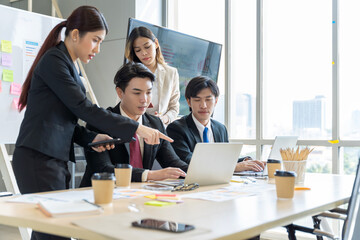A group of young Asian businessmen Talking and planning work happily and have fun. at the company's office