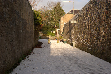 Pedestrian walkway into Darnick on snowy winters afternoon