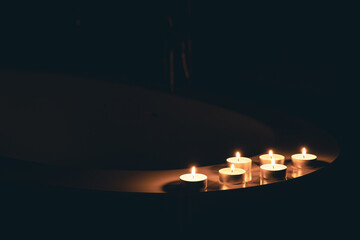 Burning candles in the bathroom in the dark.