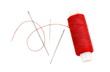 Needle with multi-colored threads on a white background. Eye of a needle close-up isolate