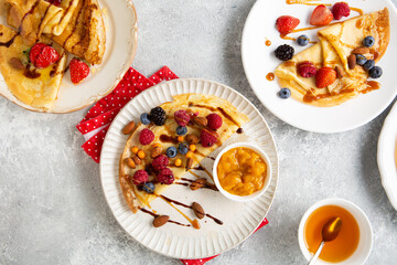 Crepes with berries and jam on plate breakfast food on light surface Pancakes day