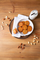 Top view of poppy seeds cookies with nut milk bottle