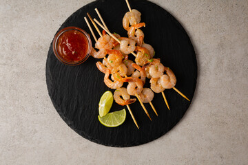 Grilled prawn skewers on slate seafood lime dip