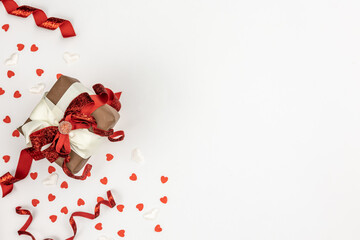 Flat lay, white background with gift box and valentine's day decor details.