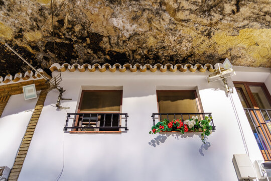 Houses dug into the rock of the mountain in the picturesque village of Setenil, Cadiz, Spain.