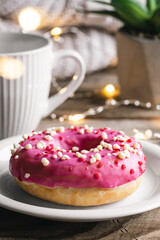 Cozy composition with donut and cup of tea.