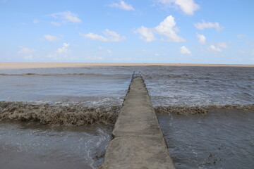 Georgetown, Guyana. 18-10-2022. The very muddy brown breaking waves due to all the rivers of the atlantic ocean in Georgetown.