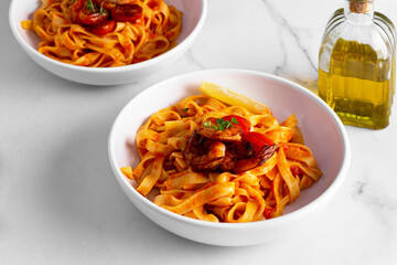 pasta with shrimps and tomatoes on a white background