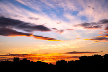 Fototapeta premium in the city, at sunrise over buildings. Cloudscape in the Morning.