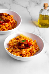 pasta with shrimps and tomatoes on a white background