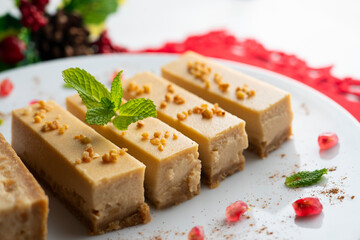 Cheesecake and almond nougat. Typical Christmas dessert served on a table with Christmas decorations.