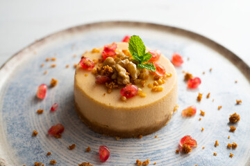 Cheesecake and almond nougat. Typical Christmas dessert served on a table with Christmas decorations.