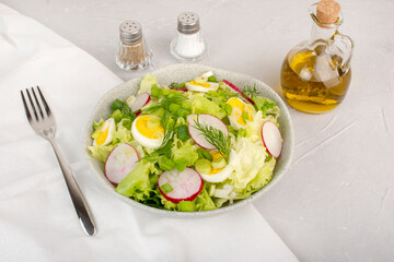 Green salad with boiled eggs, mix of vegetables, healthy food concept