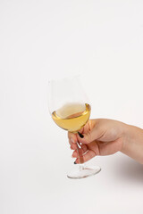 Woman hand shaking white wine glass isolated on white background