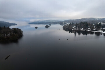 Lake Windermere,  Lake District in England in winter with snow on the ground. Aerial drone above view.