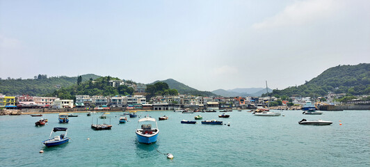 Fototapeta na wymiar Sunny day vacation waiting for a boat at a pier at Lamma Island, Hongkong.