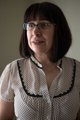 Portrait of a cute middle-aged brunette woman in glasses.