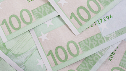 Notes of 100 euros close-up. Light background about economy and finance of European Union. News pale wallpaper about euro. Eurozone currency and ECB. Banking in Europe. Macro