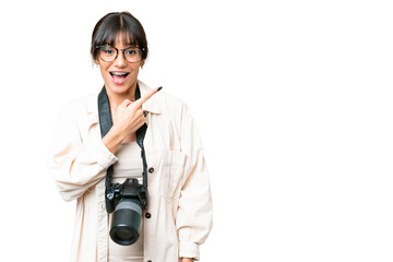 Fototapeta premium Young photographer caucasian woman over isolated chroma key background surprised and pointing side
