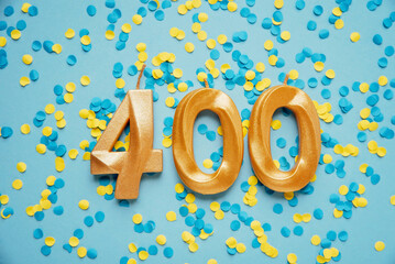 400 four hundred followers card golden birthday candle on yellow and blue confetti Background....