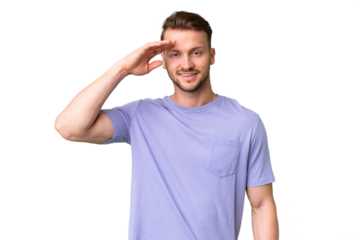 Young handsome caucasian man over isolated chroma key background saluting with hand with happy expression