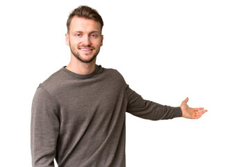 Fototapeta premium Young handsome caucasian man over isolated chroma key background extending hands to the side for inviting to come