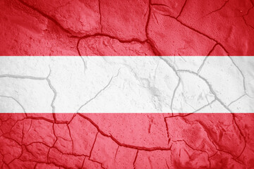 Flag of Austria. Austria symbol. Flag on the background of dry cracked earth. Austrian flag with drought concept