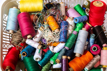 A box with multicolored coils of different threads in close-up