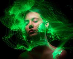 Abstract photography in the style of light painting. girl on a black background	