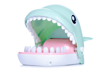 game toy shark biting finger on white background isolation