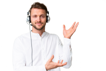 Telemarketer caucasian man working with a headset over isolated chroma key background extending hands to the side for inviting to come