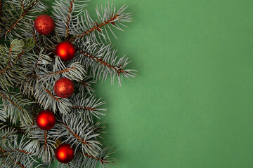Festive background from christmas tree branches with red balls.Negative space for text.