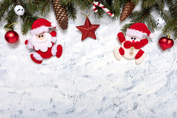 Fototapeta na wymiar Christmas decorations and fir tree on white-grey background