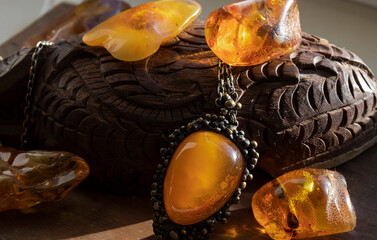 Shiny translucent yellow  old  Baltic old  amber pendant and amber stones. Amber jewelry near the...