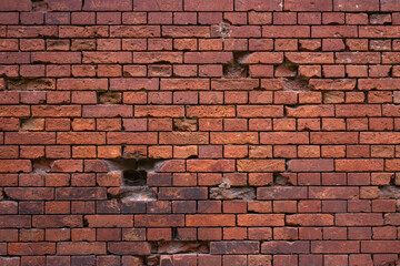 Red brick wall with holes from shots in the Brest Fortress.