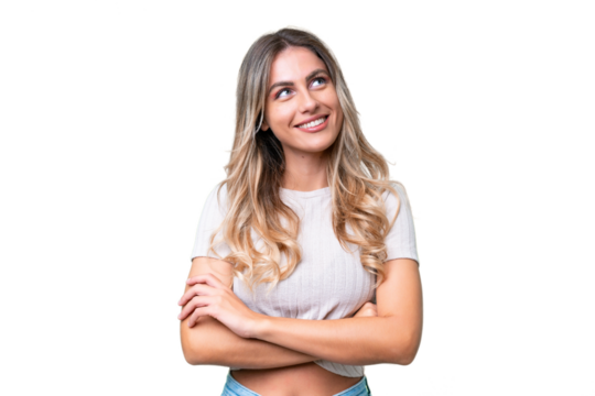 Young Uruguayan woman over isolated background looking up while smiling