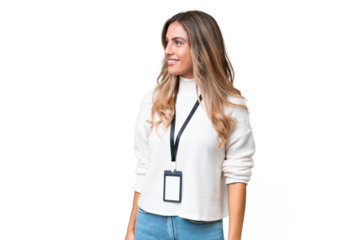 Young Uruguayan woman with ID card over isolated background looking to the side