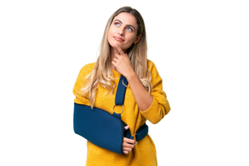 Young Uruguayan woman with broken arm and wearing a sling over isolated background having doubts