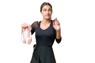 Young pretty Uruguayan woman practicing ballet over isolated background with fingers crossing and wishing the best
