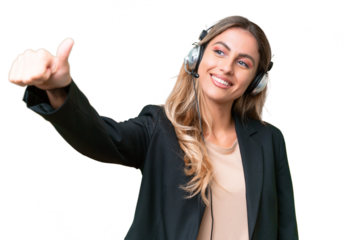 Telemarketer pretty Uruguayan woman working with a headset over isolated background giving a thumbs up gesture