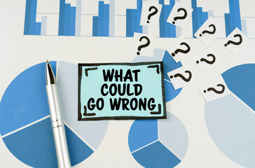 On the blue diagrams lies a pen, questions and a sticker with the inscription - what could go wrong