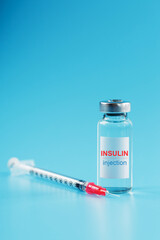 A bottle of insulin hormone and a syringe on the table