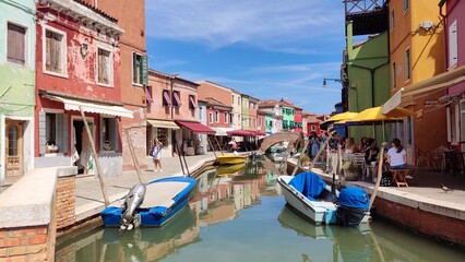 Fototapeta na wymiar View of the channel of the island of Burano, colorful houses of the island of Burano, Italy. Summer landscape