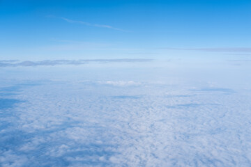 Background of a pink purple heavenly sky with fluffy dense clouds, top view from an airplane. Sky Gradient.