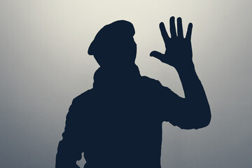 Silhouette of man waving hand in hello gesture. Anonym club concept.