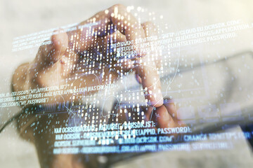 Creative code skull hologram and finger presses on a digital tablet on background, cybercrime and...