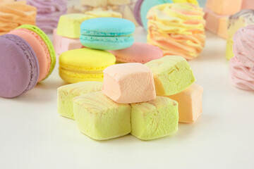 Assorted of sweetness: macaroons, marshmallows and zephyrs. Homemade colored desserts for the present.