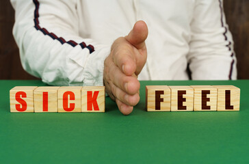 A man separates the cubes with the inscription - SICK or FEEL