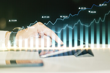 Abstract creative financial graph with finger clicks on a digital tablet on background, financial and trading concept. Multiexposure